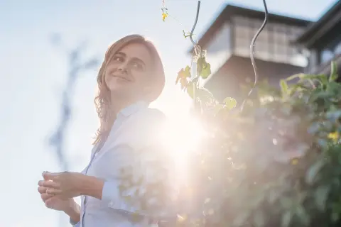 Frau im Garten im Gegenlicht.