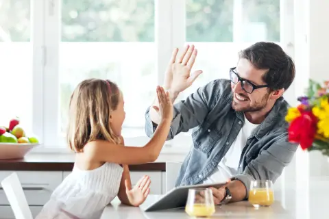 Vater und Tochter klatschen sich ab.