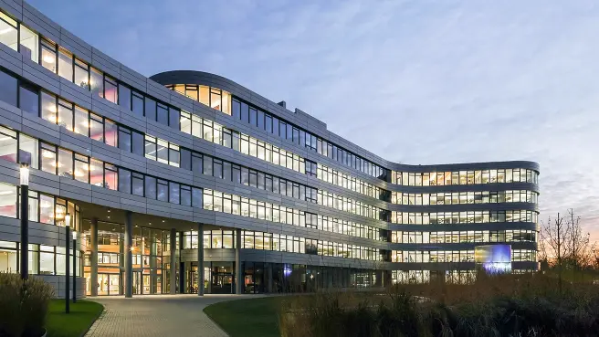 Beleuchtetes Bürogebäude in der Dämmerung