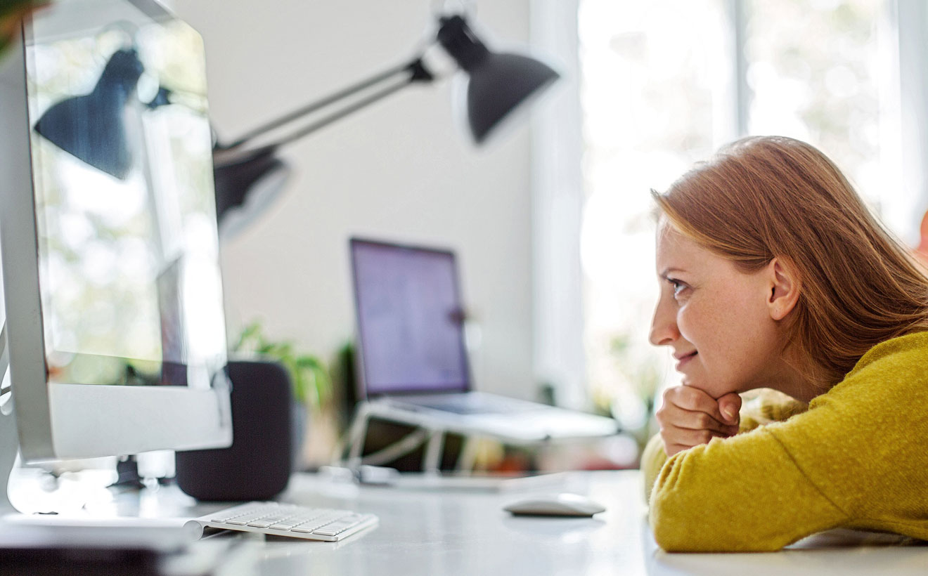 Junge Frau schaut auf den Monitor.