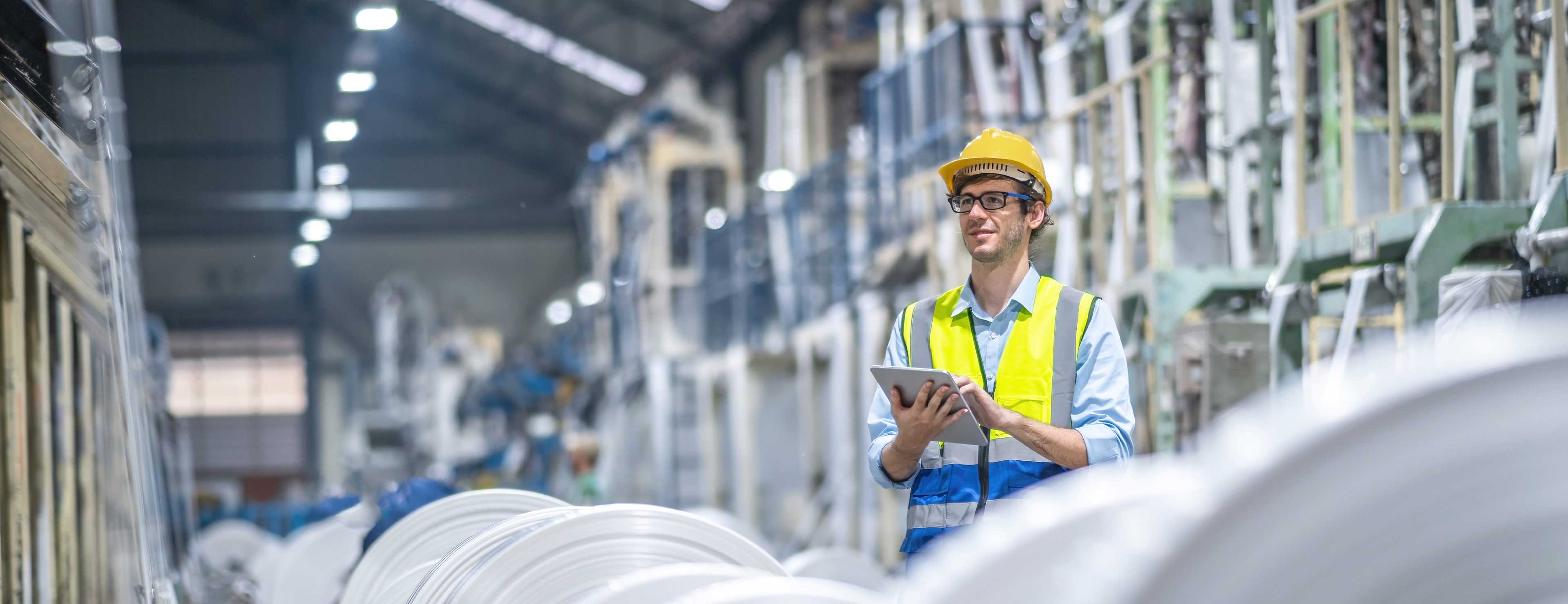 Monteur in der Produktionshalle eines Industriebetriebes